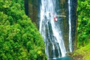 waterfall on hawaii with helicopter