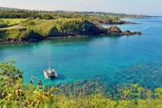 Snorkelers and a catamaran in Honolua Bay