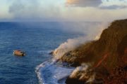 lava boat tour sees lava flowing into the ocean at the Big Island of Hawaii