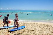 Two people taking surfing lessons at Waikiki